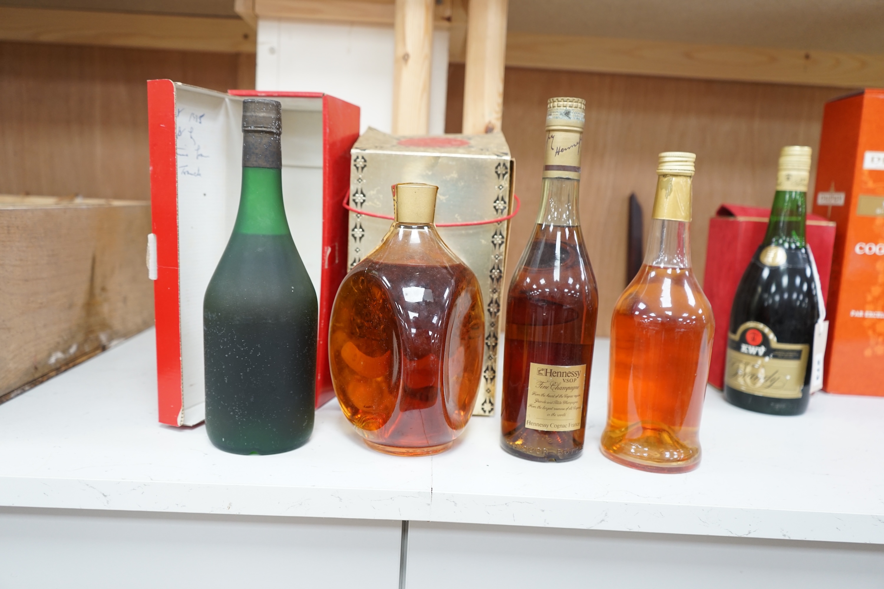 Four bottles of various alcohols comprising a bottle of 50cl Hennessey Fine Champagne Cognac, Planty Fine Cognac, Dimple Scotch Whisky and Glocken Apfel. Condition - fair, storage history unknown